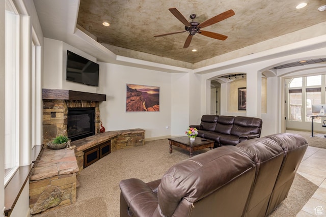 4352 W 2440 S, Hurricane, UT 84737 - carpeted living room with a raised ceiling, arched walkways, ceiling fan, a stone fireplace, and recessed lighting