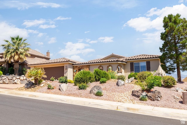 4352 W 2440 S, Hurricane, UT 84737 - mediterranean / spanish house with an attached garage, stucco siding, a tiled roof, and a chimney
