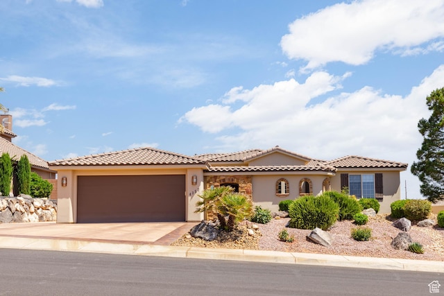 4352 W 2440 S, Hurricane, UT 84737 - mediterranean / spanish house featuring stucco siding, an attached garage, concrete driveway, and a tiled roof