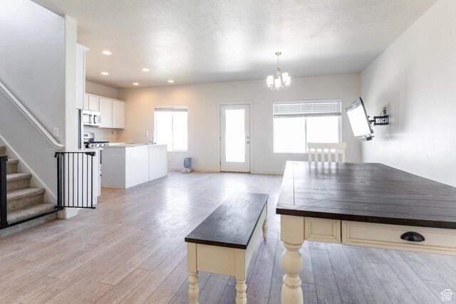 538 S Musk Ave W, Grantsville, UT 84029 - kitchen with light wood-type flooring, a chandelier, hanging light fixtures, light countertops, and recessed lighting