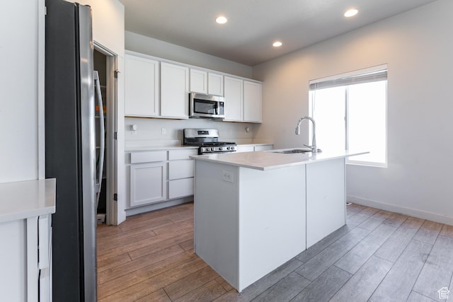 538 S Musk Ave W, Grantsville, UT 84029 - kitchen with appliances with stainless steel finishes, light wood-style flooring, light countertops, white cabinetry, and recessed lighting