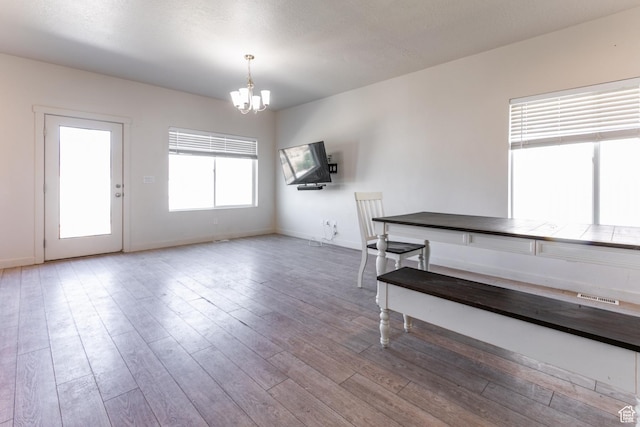 538 S Musk Ave W, Grantsville, UT 84029 - unfurnished dining area with a chandelier and wood finished floors