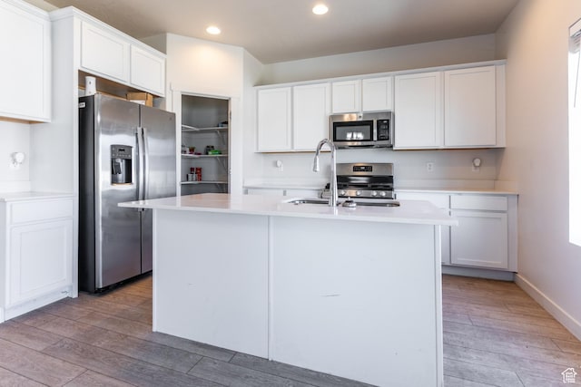 538 S Musk Ave W, Grantsville, UT 84029 - kitchen with stainless steel appliances, recessed lighting, light wood-style flooring, white cabinets, and light countertops