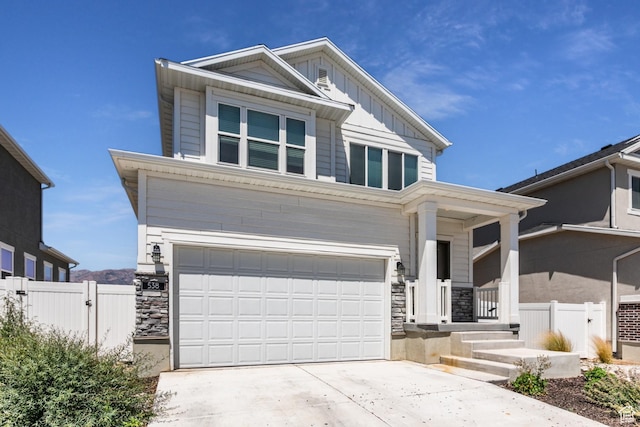 538 S Musk Ave W, Grantsville, UT 84029 - view of front of home with a garage, driveway, board and batten siding, stone siding, and covered porch