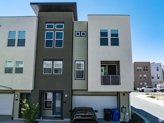604 N Sego Way Unit 207, Farmington, UT 84025 - view of property featuring stucco siding and a garage