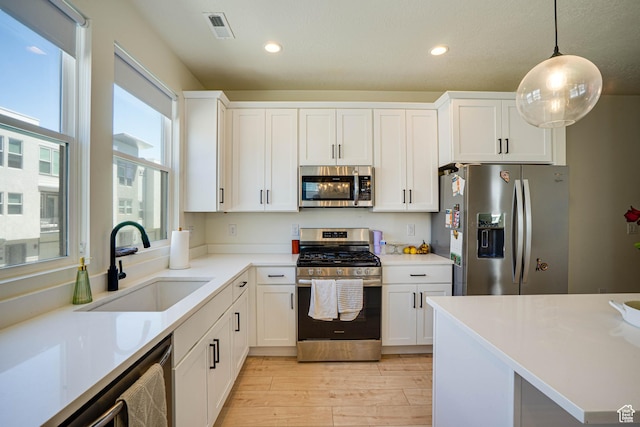 604 N Sego Way Unit 207, Farmington, UT 84025 - kitchen featuring stainless steel appliances, light wood-type flooring, white cabinets, and recessed lighting
