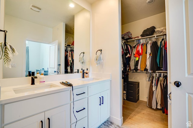604 N Sego Way Unit 207, Farmington, UT 84025 - full bath with double vanity, a spacious closet, wood finished floors, and recessed lighting