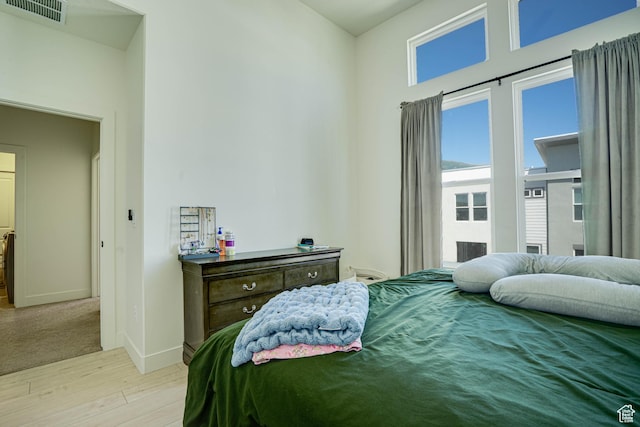 604 N Sego Way Unit 207, Farmington, UT 84025 - bedroom with light wood-style floors and baseboards