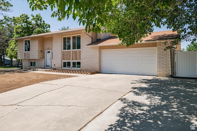 991 E Sunburn Ln, Sandy, UT 84094 - view of front of house with driveway, brick siding, and an attached garage