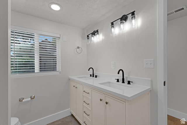 2136 Union Ave, Ogden, UT 84401 - full bathroom with a textured ceiling and double vanity