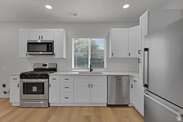 2136 Union Ave, Ogden, UT 84401 - kitchen featuring stainless steel appliances, light countertops, white cabinets, recessed lighting, and light wood finished floors