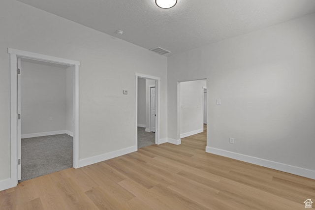 2136 Union Ave, Ogden, UT 84401 - unfurnished room featuring light wood finished floors, a textured ceiling, and a smoke detector