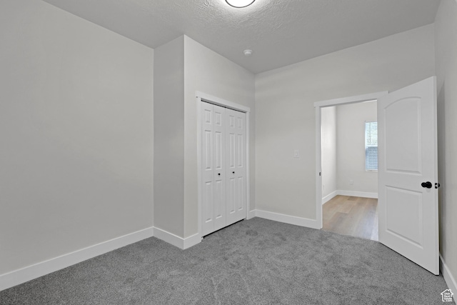 2136 Union Ave, Ogden, UT 84401 - unfurnished bedroom featuring carpet, a closet, and a textured ceiling