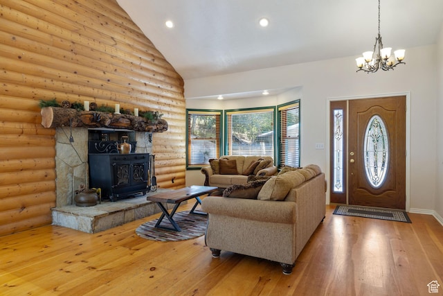610 S Maple Dr, Woodland Hills, UT 84653 - living room featuring rustic walls, wood-type flooring, a chandelier, high vaulted ceiling, and a wood stove