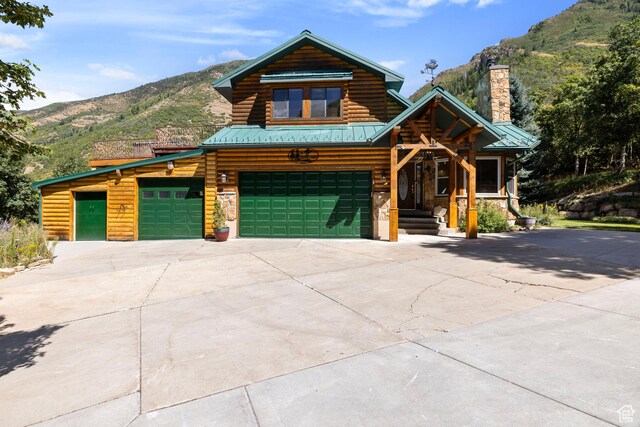 610 S Maple Dr, Woodland Hills, UT 84653 - view of front of house featuring a mountain view, a chimney, driveway, and a garage
