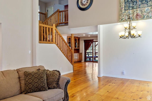 610 S Maple Dr, Woodland Hills, UT 84653 - living area featuring a chandelier, stairs, wood finished floors, and a towering ceiling