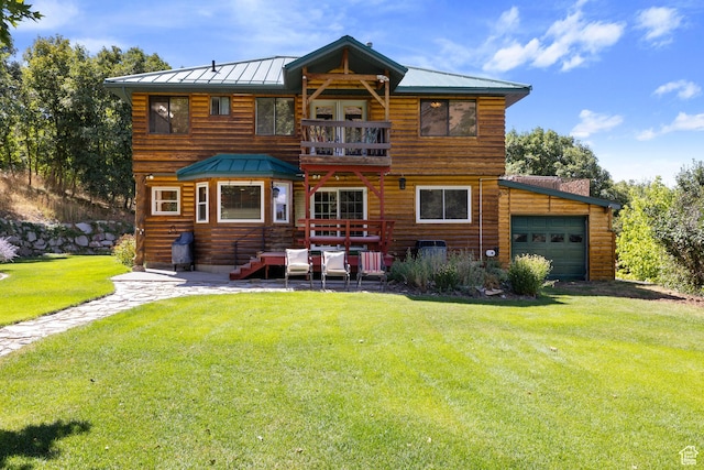 610 S Maple Dr, Woodland Hills, UT 84653 - rear view of property with a balcony, a standing seam roof, a lawn, an attached garage, and a metal roof