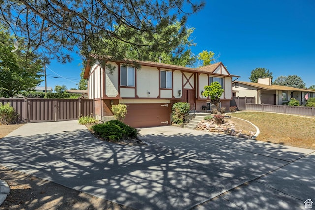 6292 S Mount Vista Dr, Taylorsville, UT 84129 - tudor home featuring stucco siding, driveway, and a garage
