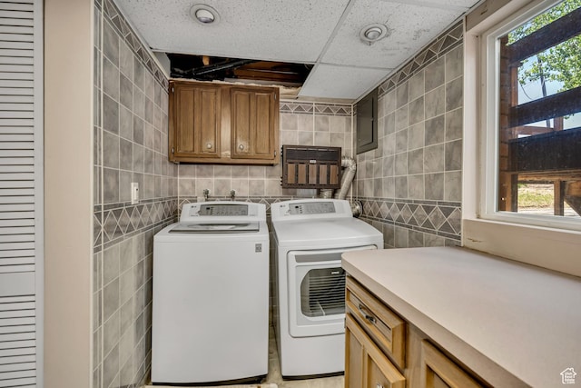 6292 S Mount Vista Dr, Taylorsville, UT 84129 - laundry area with cabinet space, tile walls, separate washer and dryer, and plenty of natural light