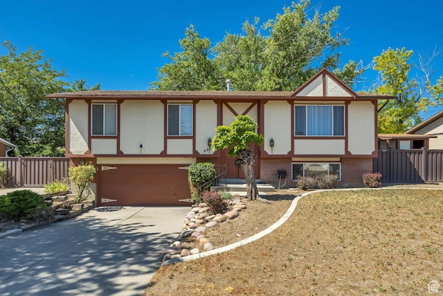 6292 S Mount Vista Dr, Taylorsville, UT 84129 - view of front facade with a garage, driveway, brick siding, and stucco siding