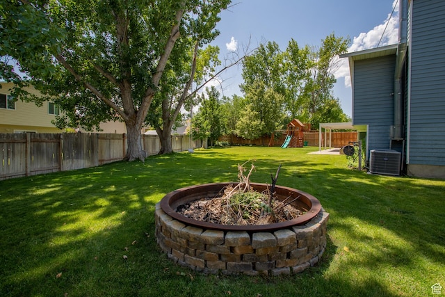 5183 W Cadenza Dr, West Jordan, UT 84081 - fenced backyard featuring a fire pit and a playground