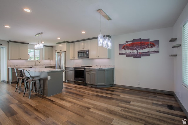 5183 W Cadenza Dr, West Jordan, UT 84081 - kitchen with stainless steel appliances, dark wood-style flooring, a kitchen island, recessed lighting, and a chandelier