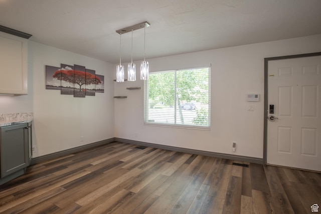5183 W Cadenza Dr, West Jordan, UT 84081 - unfurnished dining area featuring dark wood-type flooring and baseboards