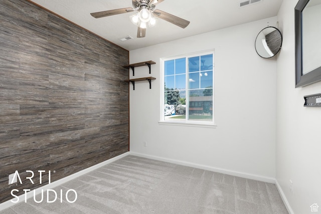 5241 S 1250 W, Riverdale, UT 84405 - carpeted spare room with wood walls, a ceiling fan, and an accent wall