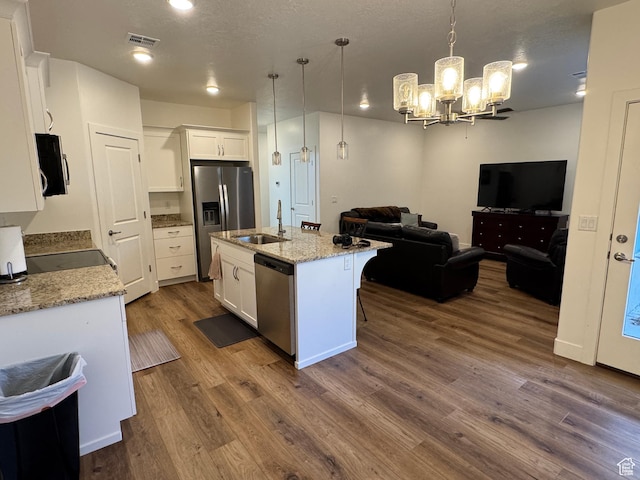 503 S Stewart Creek Cv, Washington, UT 84780 - kitchen featuring stainless steel appliances, open floor plan, dark wood-style floors, and white cabinets