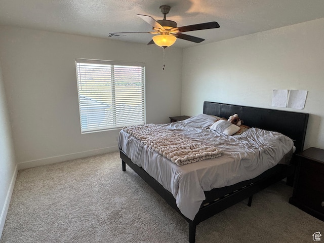503 S Stewart Creek Cv, Washington, UT 84780 - bedroom with light colored carpet, a textured ceiling, and a ceiling fan