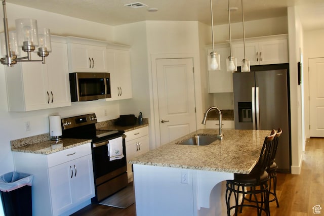 503 S Stewart Creek Cv, Washington, UT 84780 - kitchen featuring appliances with stainless steel finishes, dark wood-style flooring, white cabinets, and light stone countertops