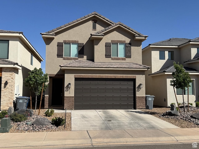 503 S Stewart Creek Cv, Washington, UT 84780 - traditional home featuring concrete driveway, a garage, stucco siding, and brick siding