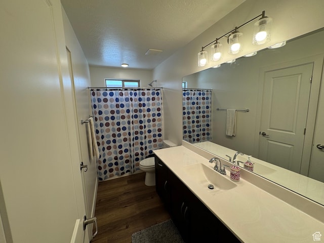 503 S Stewart Creek Cv, Washington, UT 84780 - full bathroom with wood finished floors, a textured ceiling, a shower with shower curtain, and vanity