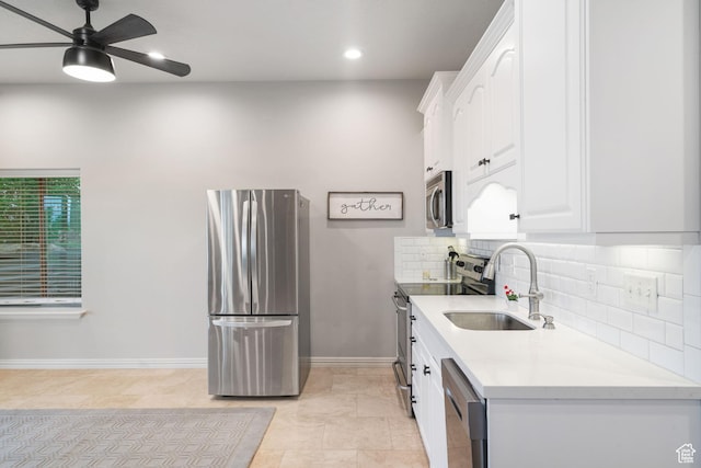 311 E Edgemont Dr S, North Salt Lake, UT 84054 - kitchen with stainless steel appliances, white cabinets, light countertops, a ceiling fan, and recessed lighting