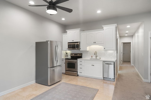 311 E Edgemont Dr S, North Salt Lake, UT 84054 - kitchen with appliances with stainless steel finishes, light countertops, a ceiling fan, white cabinetry, and decorative backsplash