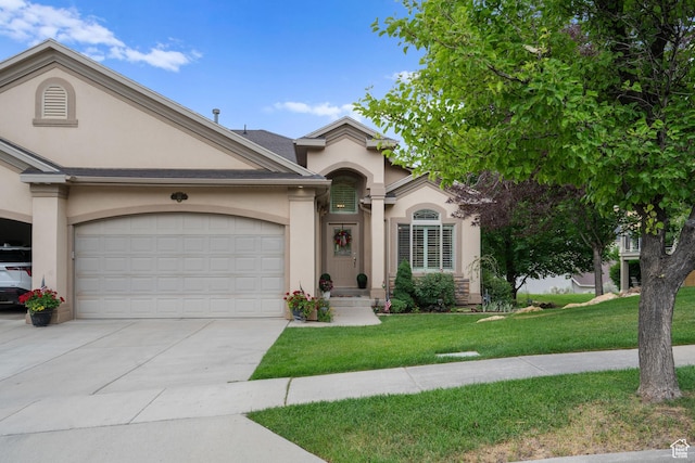 311 E Edgemont Dr S, North Salt Lake, UT 84054 - view of front of home featuring stucco siding, an attached garage, concrete driveway, and a front yard