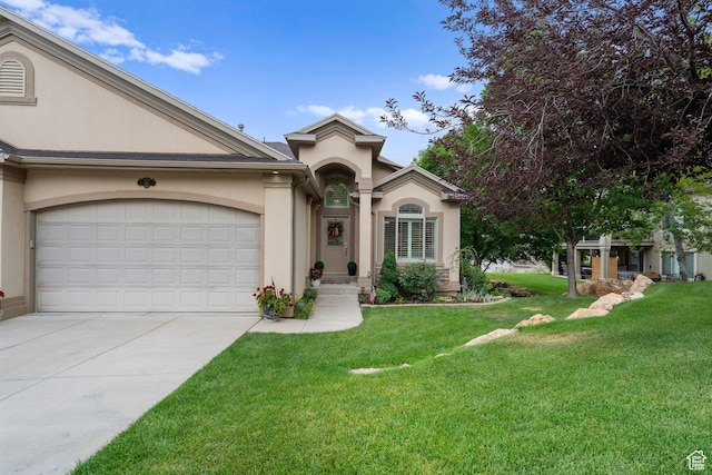 311 E Edgemont Dr S, North Salt Lake, UT 84054 - view of front of property featuring stucco siding, driveway, a front lawn, and a garage