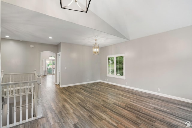 311 E Edgemont Dr S, North Salt Lake, UT 84054 - unfurnished room with arched walkways, dark wood finished floors, a chandelier, lofted ceiling, and recessed lighting