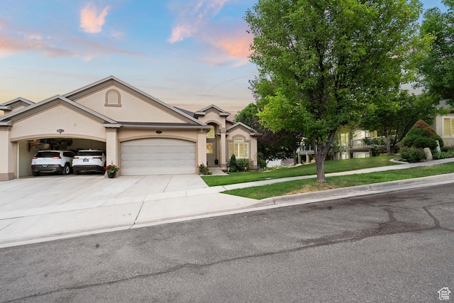 311 E Edgemont Dr S, North Salt Lake, UT 84054 - ranch-style home featuring stucco siding, a garage, concrete driveway, and a front lawn