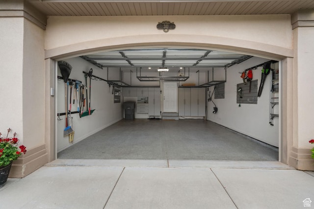 311 E Edgemont Dr S, North Salt Lake, UT 84054 - garage with baseboards and a garage door opener