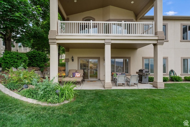 311 E Edgemont Dr S, North Salt Lake, UT 84054 - rear view of property featuring a balcony, stucco siding, a lawn, and a patio area
