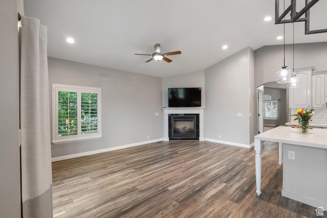 311 E Edgemont Dr S, North Salt Lake, UT 84054 - unfurnished living room featuring a ceiling fan, dark wood finished floors, a fireplace, recessed lighting, and lofted ceiling