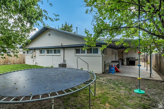 1517 S 700 W, Woods Cross, UT 84087 - back of house with a trampoline, a fenced backyard, and a patio area