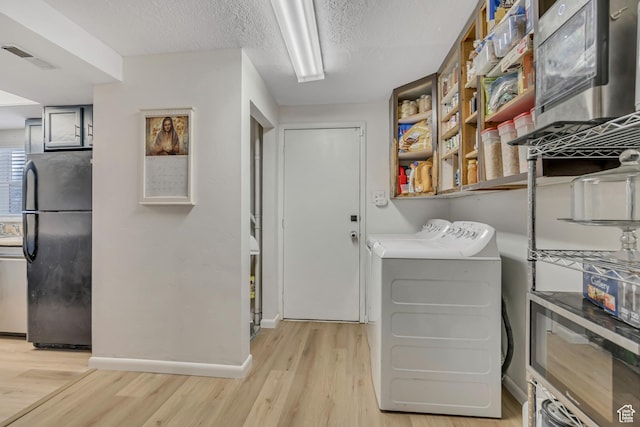 1517 S 700 W, Woods Cross, UT 84087 - laundry room featuring independent washer and dryer, light wood-style floors, and a textured ceiling