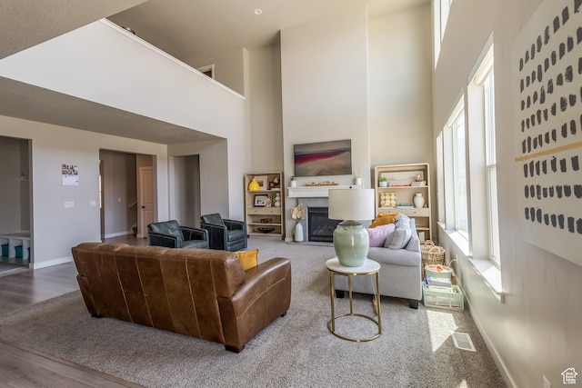 69 W 2200 S, Kaysville, UT 84037 - living room with a glass covered fireplace, a towering ceiling, and wood finished floors