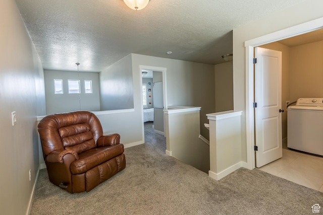 69 W 2200 S, Kaysville, UT 84037 - sitting room with washer / clothes dryer, an upstairs landing, a textured ceiling, and light colored carpet