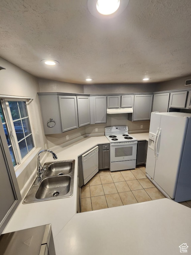 1132 W 1390 S, Orem, UT 84058 - kitchen with white appliances, under cabinet range hood, a textured ceiling, gray cabinets, and light countertops