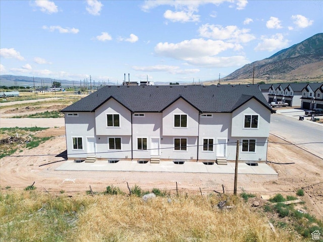 217 W 815 N Unit 20, Nephi, UT 84648 - back of house featuring a mountain view, stucco siding, and a shingled roof