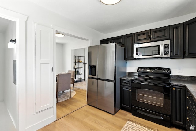 291 S 700 E, Spanish Fork, UT 84660 - kitchen featuring appliances with stainless steel finishes, dark countertops, dark cabinets, and light wood-style floors