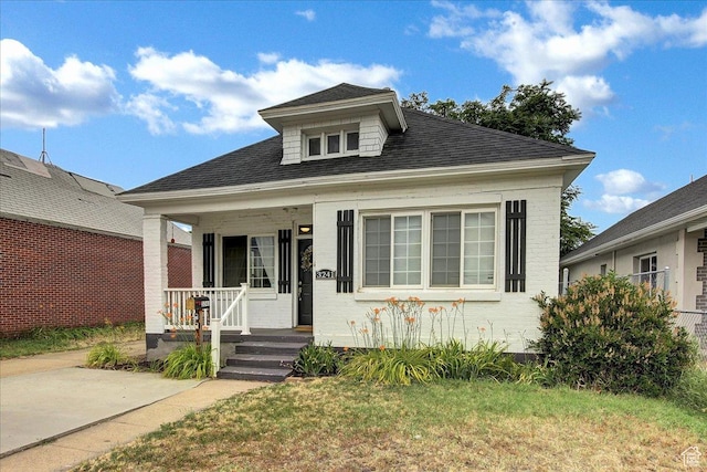 3241 Grant Ave, Ogden, UT 84401 - view of front of property with covered porch, brick siding, and a shingled roof